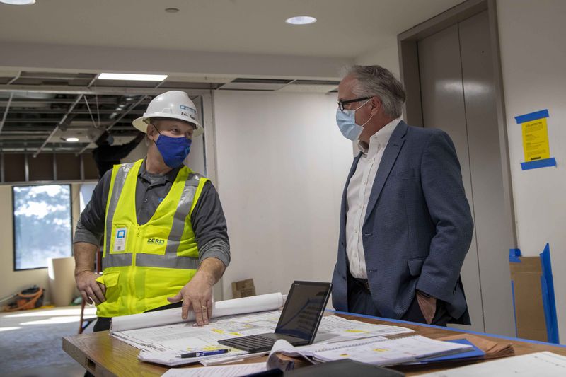 01/29/2021 — Atlanta, Georgia — Cornerstone Contracting Superintendent Eric Goss (left) speaks with Boxer Property regional leasing manager David Barry during construction at an office building owned by Boxer Property inside the Northlake Office Park in Atlanta, Friday, January 29, 2021.  (Alyssa Pointer / Alyssa.Pointer@ajc.com)