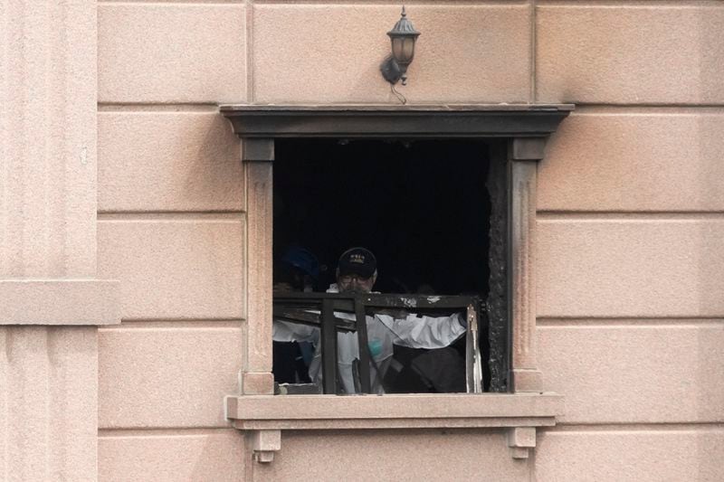 A joint investigation team examines the site of a hotel burnt by Thursday's fire in Bucheon, South Korea, Friday, Aug. 23, 2024. (AP Photo/Ahn Young-joon)