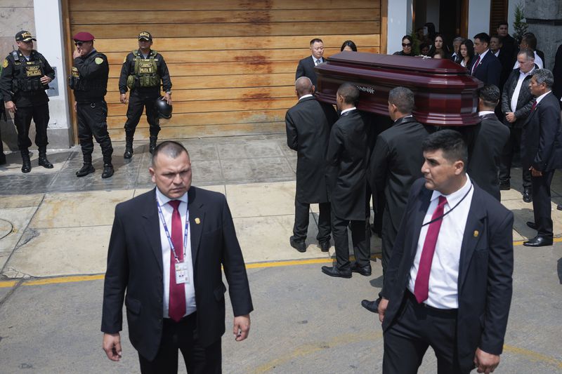 Pallbearers carry the coffin of former President Alberto Fujimori from the home of his daughter Keiko, the day after he died in Lima, Peru, Thursday, Sept. 12, 2024. (AP Photo/Guadalupe Pardo)