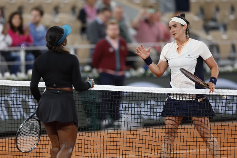 Tunisia's Ons Jabeur, right, and Sachia Vickery of the U.S. shake hands after their first round match of the French Open tennis tournament at the Roland Garros stadium in Paris, Monday, May 27, 2024. (AP Photo/Jean-Francois Badias)