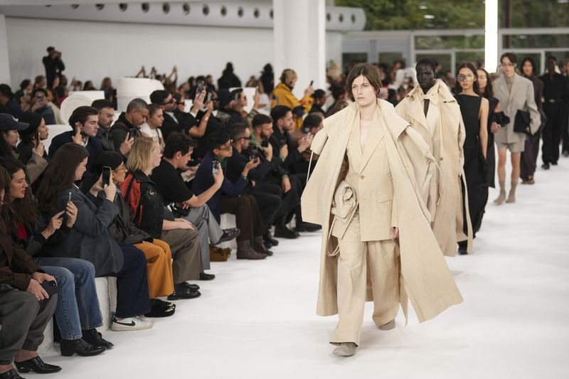 Models wear creations as part of the Issey Miyake Spring/Summer 2025 collection presented Friday, Sept. 27, 2024 in Paris. (Photo by Scott A Garfitt/Invision/AP)