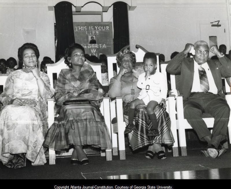 From left, Coretta Scott King, Christine Farris, Alberta King, (holding her great-grandson Jarrett) and Martin Luther King Sr. attend an event in 1972 honoring Alberta's years as a church organist at Ebenezer Baptist Church. The fame of Martin Jr. brought many strangers and visitors to the church, which caused the family some concern. (Charles Pugh/AJC Archive at GSU Library AJCP443-116b)