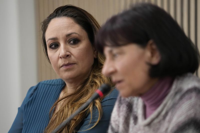 FILE - Lawyer Laura Sgro, left, listens to Gloria Branciani during a press conference in Rome, Wednesday, Feb. 21, 2024. Gloria Branciani, 59, is one of the first women who accused Rev. Marko Rupnik of spiritual, psychological, and sexual abuse. Sgro wrote a letter representing five women who say they were psychologically, spiritually, and sexually abused by ex-Jesuit artist Rev. Marko Rupnik, that asks Catholic bishops around the world on Friday, June 28, 2024, to remove his mosaics from their churches, saying their continued display in places of worship was "inappropriate" and retraumatizing to victims. (AP Photo/Alessandra Tarantino, File)