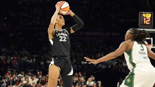 Las Vegas Aces center A'ja Wilson (22) keeps the ball away from Seattle Storm forward Nneka Ogwumike (3) during a first-round WNBA basketball playoff game Sunday, Sept. 22, 2024, in Las Vegas. (AP Photo/Ronda Churchill)