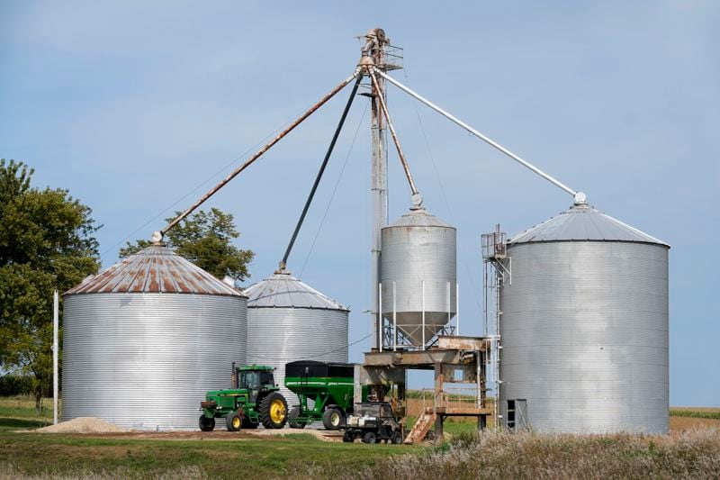 A farmer empties corn in storage bins on a farm, Monday, Sept. 16, 2024, in Wyoming, Iowa. (AP Photo/Charlie Neibergall)