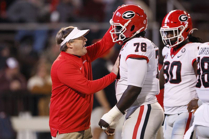 Georgia head coach Kirby Smart talks with defensive lineman Nazir Stackhouse (78) before their game against the Mississippi State Bulldogs at Davis Wade Stadium, Saturday, November 12, 2022, in Starkville, Mississippi. Jason Getz / Jason.Getz@ajc.com)