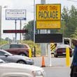 A person walks through the parking lot of a strip of businesses along Glenwood Road near its intersection with Columbia Drive in southern DeKalb County. on Wednesday, September 25, 2024. (Arvin Temkar / AJC)