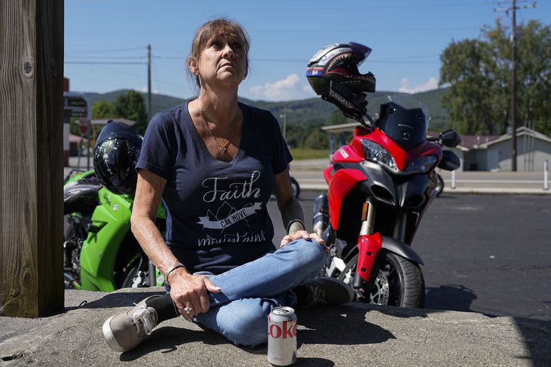 FILE - Karen Goodwin rests at a roadside market during a motorcycle ride along U.S. Highway 421, also known as The Snake, Friday, Sept. 22, 2023, in Shady Valley, Tenn. Goodwin's son, Austin Hunter Turner, died in 2017 at the age of 23 after an encounter with the Bristol Police Department. (AP Photo/George Walker IV, File)