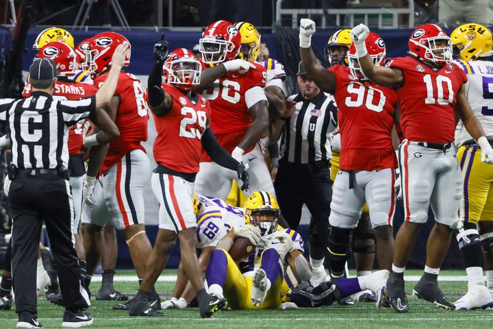 LSU Tigers running back Josh Williams (27) is stopped by Georgia Bulldogs defenders on a fourth down play during the second half of the SEC Championship Game at Mercedes-Benz Stadium in Atlanta on Saturday, Dec. 3, 2022. (Bob Andres / Bob Andres for the Atlanta Constitution)