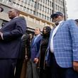 Rev. J. Lawrence Turner, left, leads a prayer vigil with the mother and stepfather of Tyre Nichols, RowVaughn Wells, second from right, and Rodney Wells, right, outside the federal courthouse during the trial of three former Memphis police officers accused of killing her son Wednesday, Sept. 25, 2024, in Memphis, Tenn. (AP Photo/George Walker IV)