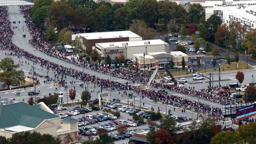 Fans await the World Series champion Atlanta Braves on Cobb Parkway on Friday, Nov. 5, 2021, amid the team's parade to Truist Park in Cobb County, Georgia. (Curtis Compton/Atlanta Journal-Constitution/TNS)