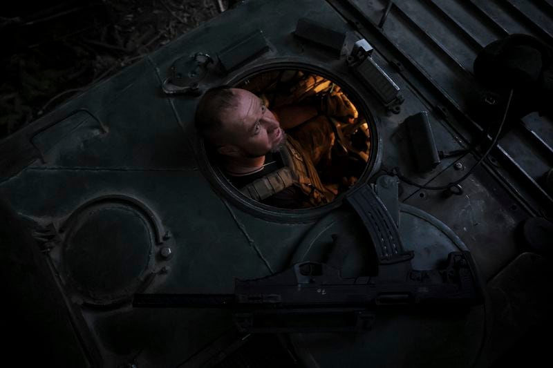 In this photo provided by Ukraine's 24th Mechanised Brigade press service, a soldier of the 24th mechanised brigade looks out of a BRM1k infantry fighting vehicle as he prepares to fire towards Russian positions near Chasiv Yar town, in Donetsk region, Ukraine, Saturday Aug. 17, 2024. (Oleg Petrasiuk/Ukrainian 24th Mechanised Brigade via AP)