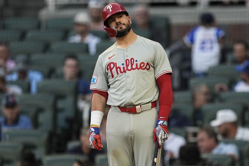 Philadelphia Phillies designated hitter Kyle Schwarber (12) reacts to a pitch in the third inning of a baseball game against the Atlanta Braves, Thursday, Aug. 22, 2024, in Atlanta. (AP Photo/Mike Stewart)