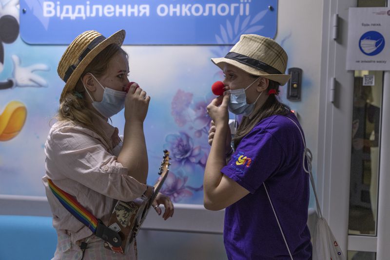 Vladyslava Kulinich, right, Tetiana Nosova, who have the clown names Lala and Zhuzha, prepare to perform at Okhmatdyt children's hospital in Kyiv, Ukraine, Thursday Sept. 19, 2024. (AP Photo/Anton Shtuka)