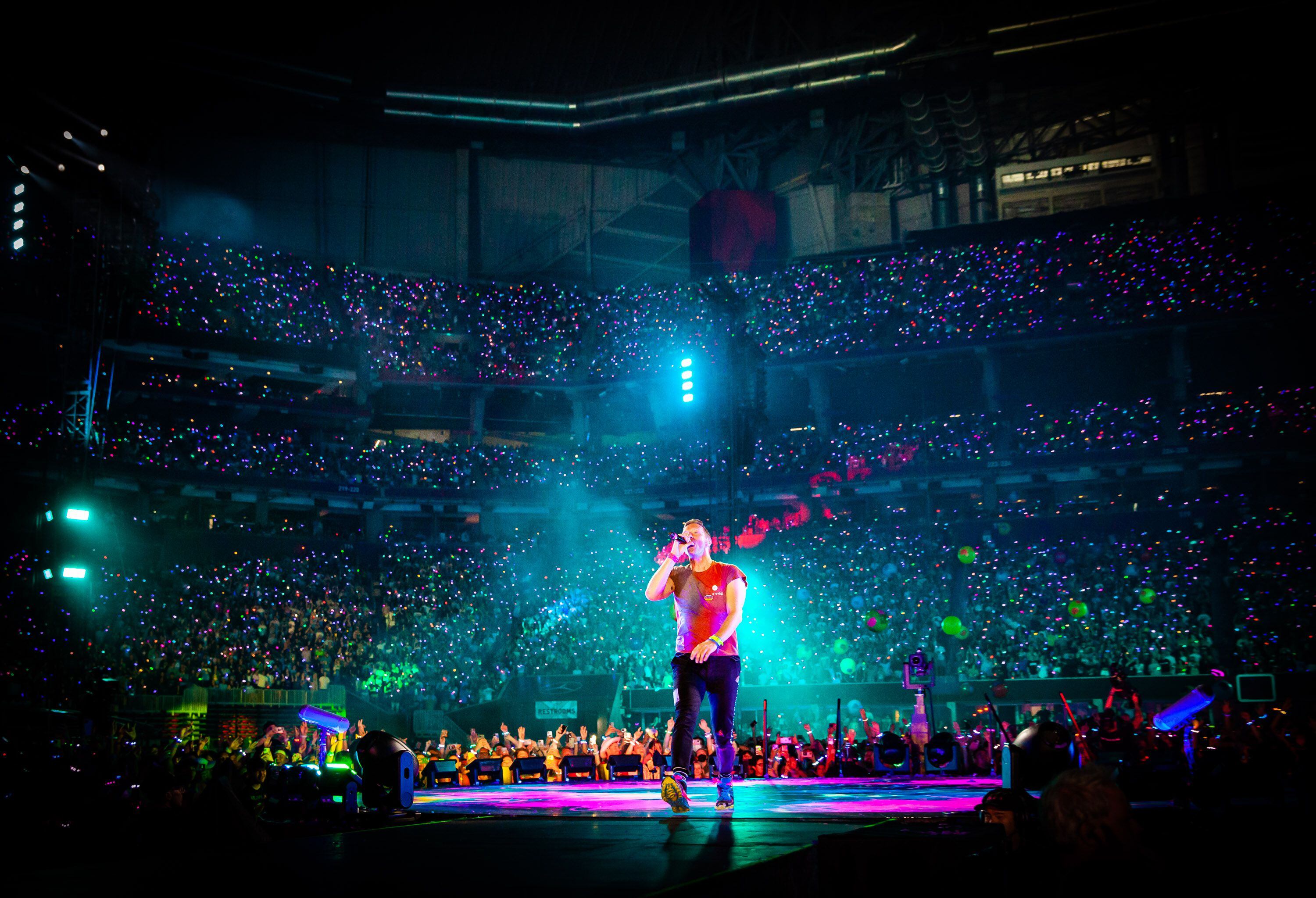 Will Champion of Coldplay performs on stage at Wembley Stadium