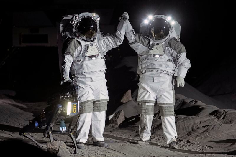 Astronauts Thomas Pesquet of France and Matthias Maurer of Germany demonstrate their training in lunar surface simulating conditions for future moon missions, like the Artemis lunar exploration program led by NASA, at the opening of the new LUNA facility at the European Astronaut Center in Cologne, Germany, Wednesday, Sept. 25, 2024. (AP Photo/Martin Meissner)