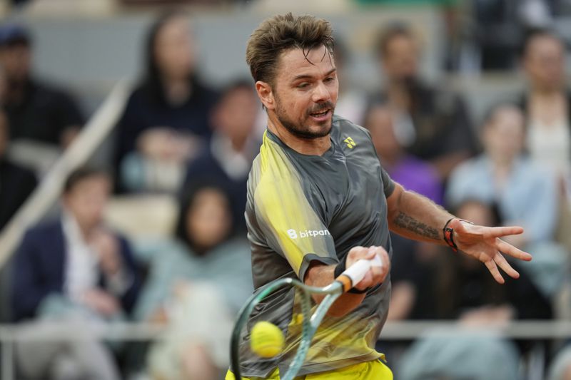 Switzerland's Stan Wawrinka plays a shot against Britain's Andy Murray during their first round match of the French Open tennis tournament at the Roland Garros stadium in Paris, Sunday, May 26, 2024. (AP Photo/Thibault Camus)