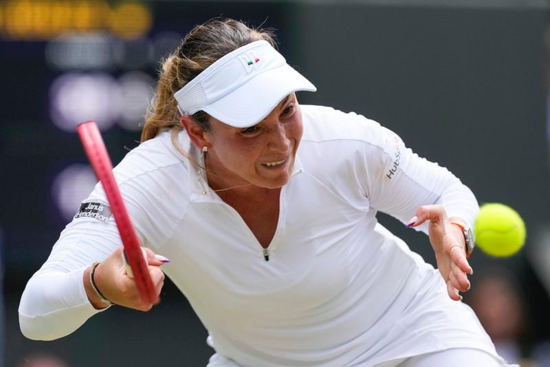 Donna Vekic of Croatia plays a forehand return to Jasmine Paolini of Italy during their semifinal match at the Wimbledon tennis championships in London, Thursday, July 11, 2024. (AP Photo/Alberto Pezzali)