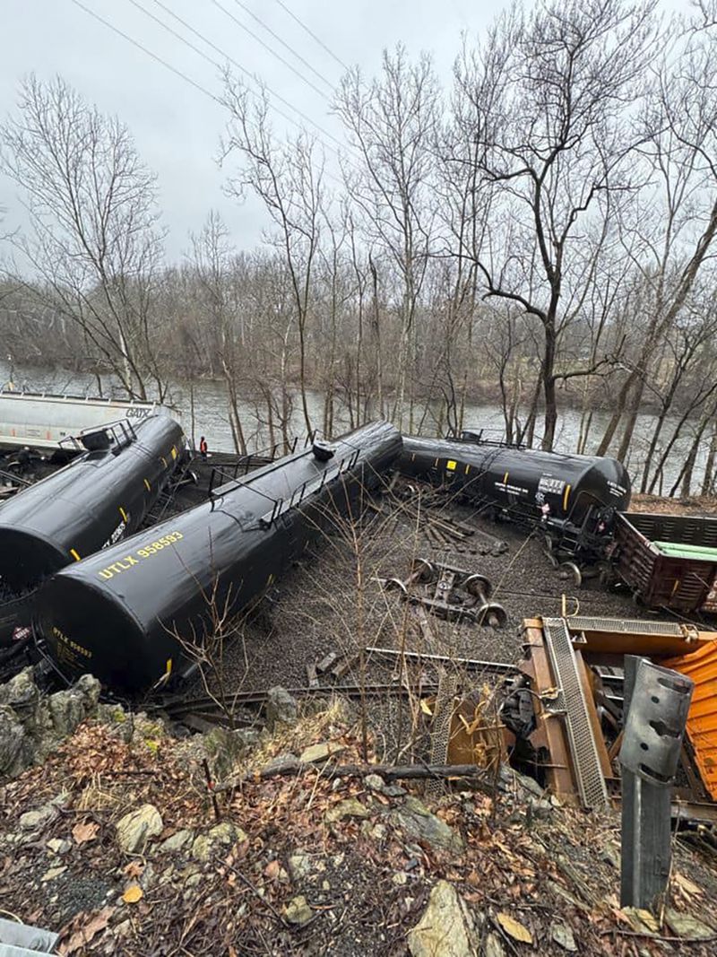 This photo provided by Nancy Run Fire Company shows a train derailment along a riverbank in Saucon Township, Pa., on Saturday, March 2, 2024.   Authorities said it was unclear how many cars were involved but no injuries or hazardous materials were reported.   (Nancy Run Fire Company via AP)