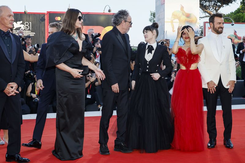 Michael Keaton, from left, Monica Bellucci, director Tim Burton, Winona Ryder, Jenna Ortega and Justin Theroux pose for photographers upon arrival for the premiere of the film 'Beetlejuice Beetlejuice' and the opening ceremony of the 81st edition of the Venice Film Festival in Venice, Italy, on Wednesday, Aug. 28, 2024. (Photo by Joel C Ryan/Invision/AP)