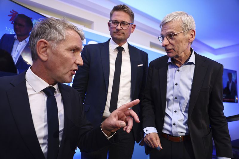 AfD state chairman, Bjoern Hoecke, left, spokesman for the AfD Thuringia state association, and Hans-Christoph Berndt, deputy chairman of the AfD Brandenburg and top candidate, talk at the AfD election party for the state election in the German state of Brandenburg in Potsdam, Germany, Sunday Sept. 22, 2024. (Christoph Soeder/dpa via AP)