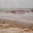 A car is submerged in flood waters outside an apartment building in the village of Kiseljak, northern Bosnia, Friday, Oct. 4, 2024. (AP Photo/Armin Durgut)