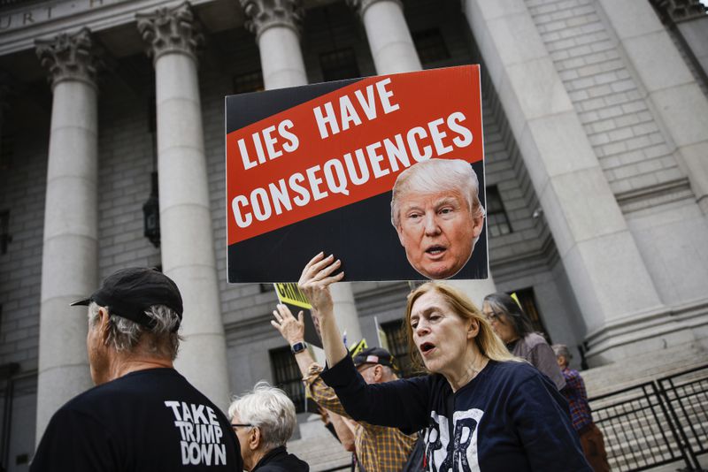 People protest against former President Donald Trump before his arrival to the New York Federal Court, Friday, Sept. 6, 2024, in New York. (AP Photo/Eduardo Munoz Alvarez)