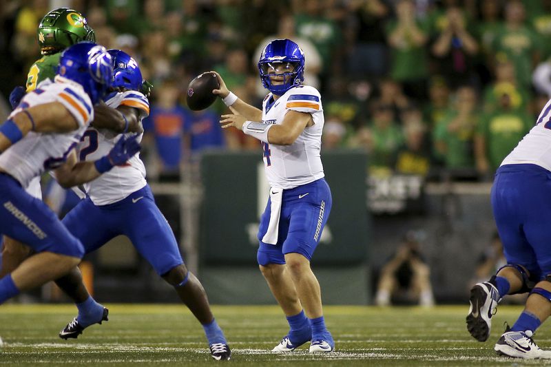 Boise State quarterback Maddux Madsen, center, looks to pass during the first half of an NCAA college football game, Saturday, Sept. 7, 2024, at Autzen Stadium in Eugene, Ore. (AP Photo/Lydia Ely)