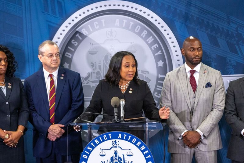 Special prosecutor Nathan Wade (right) stands next to Fulton County District Attorney Fani Willis as she announces a racketeering indictment against former President Donald Trump and others at a press conference at Fulton County Government Center in Atlanta on Monday, Aug. 14, 2023. (Arvin Temkar/Atlanta Journal-Constitution/TNS)