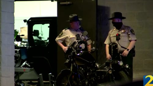 Douglas County deputies responded to an armed robbery in progress at Mountain Motorsports in Lithia Springs immediately before the shooting, according to the sheriff's office.