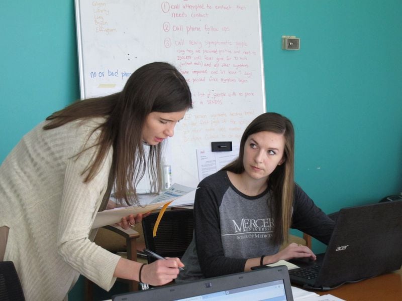 Catherine Waldron, a graduating Mercer University medical student, talks with epidemiologist Elizabeth Goff at the state Department of Public Health’s Coastal Health District in Savannah. The district has two teams of contact tracers. The first, made up of epidemiologists, is responsible for contacting and interviewing every person who tests positive for COVID-19. Students such as Waldron are part of the second team, which calls each infected person’s close contacts. AP PHOTO / RUSS BYNUM