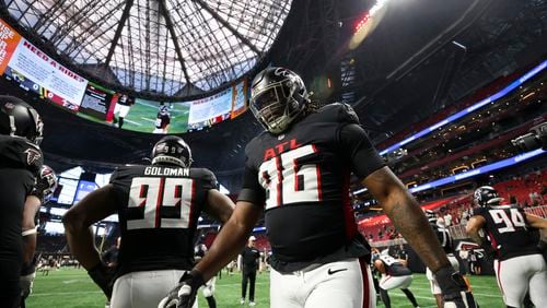 Atlanta Falcons defensive end Zach Harrison (96) and defensive tackle Eddie Goldman (99) warm-up before their game against the Jacksonville Jaguars in their preseason NFL football game at Mercedes-Benz Stadium, on Friday, Aug. 23, 2024, in Atlanta. (Jason Getz / AJC)
