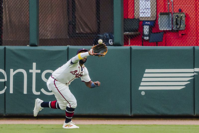 Atlanta Braves outfielder Michael Harris II catches a pop fly hit by Colorado Rockies' Brenton Doyle to right center field in the first inning of a baseball game, Tuesday, Sept. 3, 2024, in Atlanta. (AP Photo/Jason Allen)