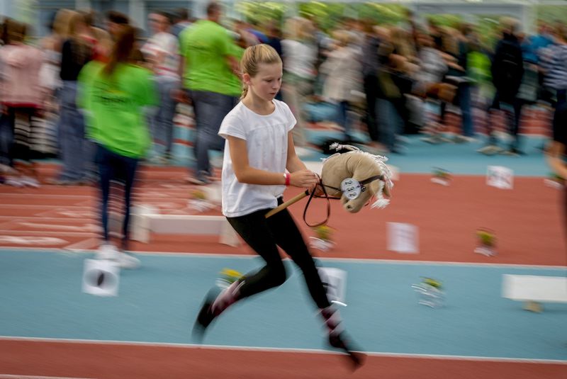 A girl competes in the dressage event at the first German Hobby Horsing Championship in Frankfurt, Germany, Saturday, Sept. 14, 2024. (AP Photo/Michael Probst)