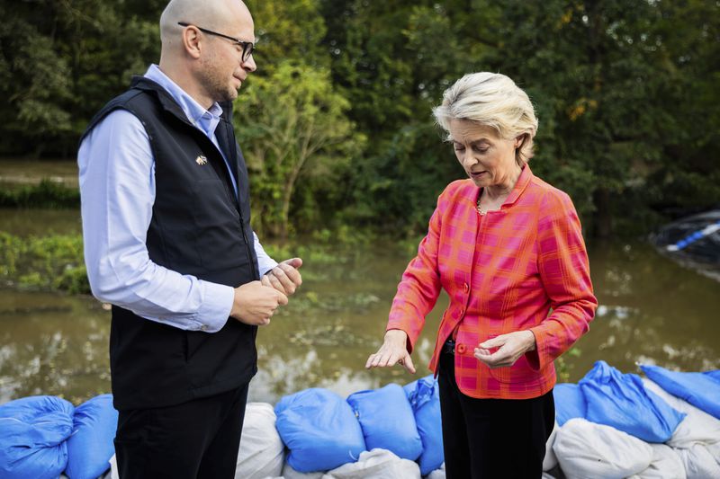 European Commmission President Ursula von der Leyen, right, talks to Jakub Mazur, First Deputy Mayor of Wroclaw, next to the river Bystrzyca near Woclaw, Poland, Thursday, Sept. 19, 2024. (Christoph Soeder/DPA via AP, Pool)