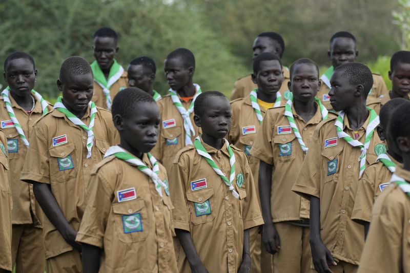 Local Scouts, who are taught about the importance of protecting the environment and building skills, gather in Lafon village, South Sudan Tuesday, June 18, 2024. African Parks is trying to square modernizing the country with preserving the wildlife. (AP Photo/Brian Inganga)