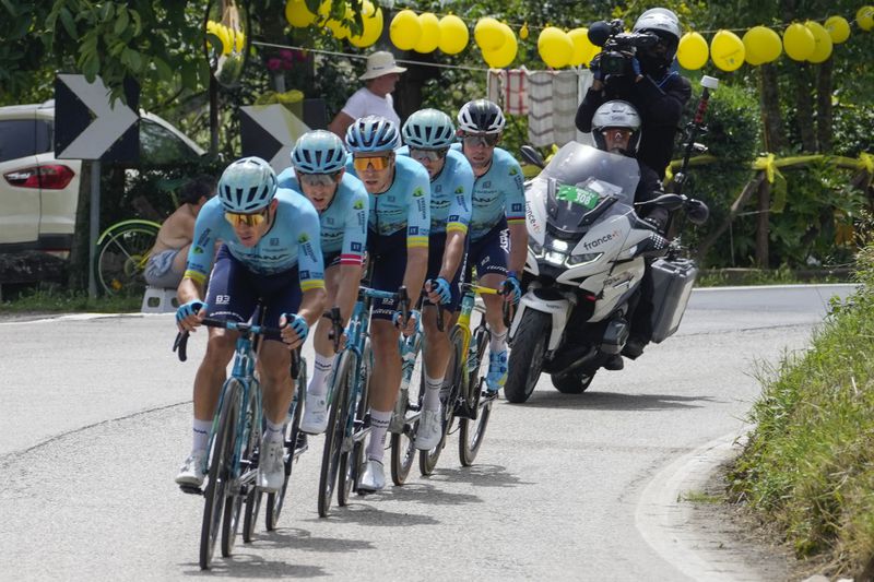Four Astana Qazaqstan Team riders set the pace for Britain's Mark Cavendish, rear, who got distanced from the pack during the first stage of the Tour de France cycling race over 206 kilometers (128 miles) with start in Florence and finish in Rimini, Italy, Saturday, June 29, 2024. (AP Photo/Jerome Delay)