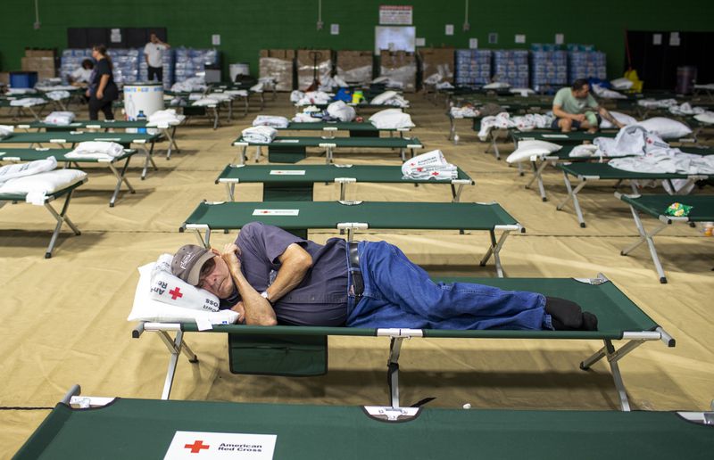 A Ruidoso resident sleeps at a shelter in Roswell, N.M., after evacuating from Ruidoso, Tuesday, June 18, 2024. Thousands of southern New Mexico residents fled the mountainous village as a wind-whipped wildfire tore through homes and other buildings. (AP Photo/Andres Leighton)