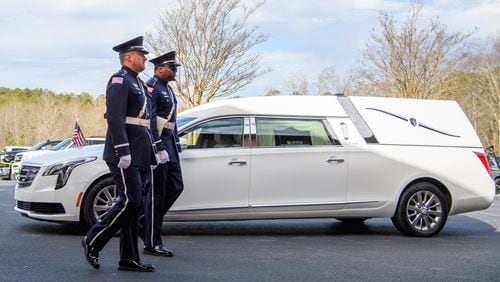 Law enforcement officers arrive for the funeral for Coweta County Deputy Eric Anthony Minix at Crossroads Church in Sharpsburg on Monday. Investigator Minix passed away during the apprehension of a vehicle theft suspect on Jan. 4. (Jamie Spaar for the Atlanta Journal Constitution)