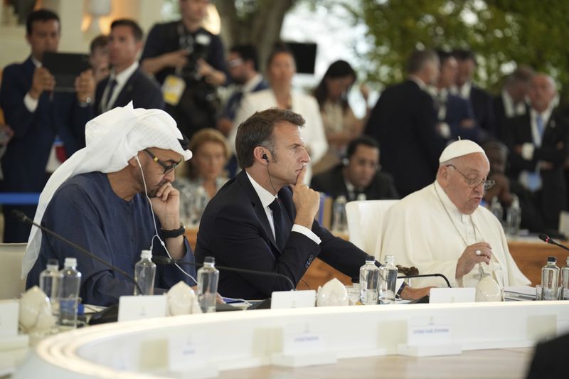 From left, United Arab Emirates President Sheikh Mohammed bin Zayed Al Nahyan and French President Emmanuel Macron listens as Pope Francis, right, speaks during a working session on Artificial Intelligence (AI), Energy, Africa-Mediterranean, on day two of the 50th G7 summit at Borgo Egnazia, southern Italy, on Friday, June 14, 2024. (Christopher Furlong/Pool Photo via AP)