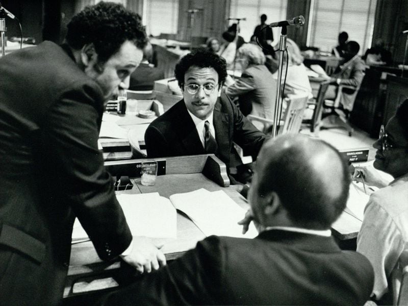 In this undated photo from the 1980s, Atlanta City Council members Jim Maddox (left), Bill Campbell (middle), and John Lewis (foreground) discuss rezoning legislation. (Michael Pugh / AJC Archive at GSU Library AJCP142-026z)