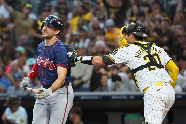 Atlanta Braves’ Matt Olson (28) strikes out and tagged by San Diego Padres catcher Kyle Higashioka (20) during the third inning of National League Division Series Wild Card Game One at Petco Park in San Diego on Tuesday, Oct. 1, 2024.   (Jason Getz / Jason.Getz@ajc.com)