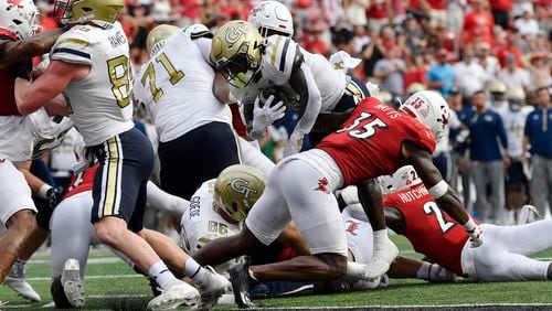 Georgia Tech running back Jamal Haynes, center, leaps over the line to score during the first half of an NCAA college football game in Louisville, Ky., Saturday, Sept. 21, 2024. (AP Photo/Timothy D. Easley)