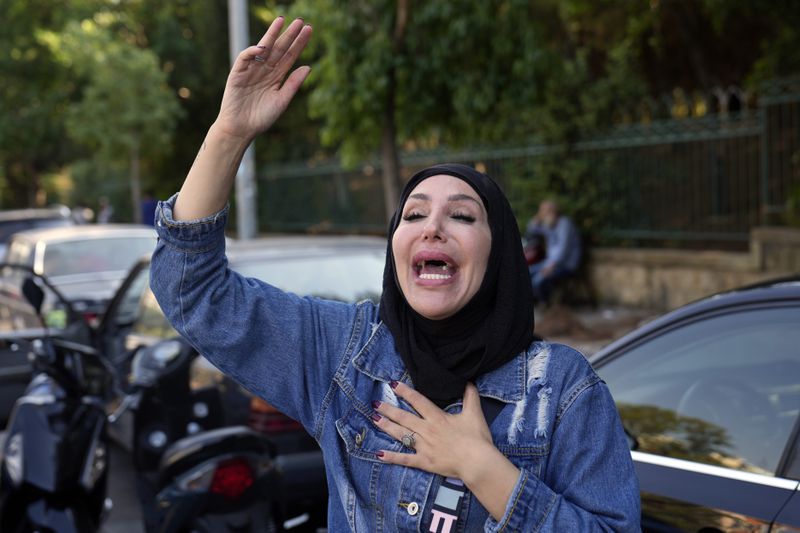 A woman reacts after hearing the news of the death of Hezbollah leader Hassan Nasrallah in Beirut, Saturday, Sept. 28, 2024. (AP Photo/Hussein Malla)