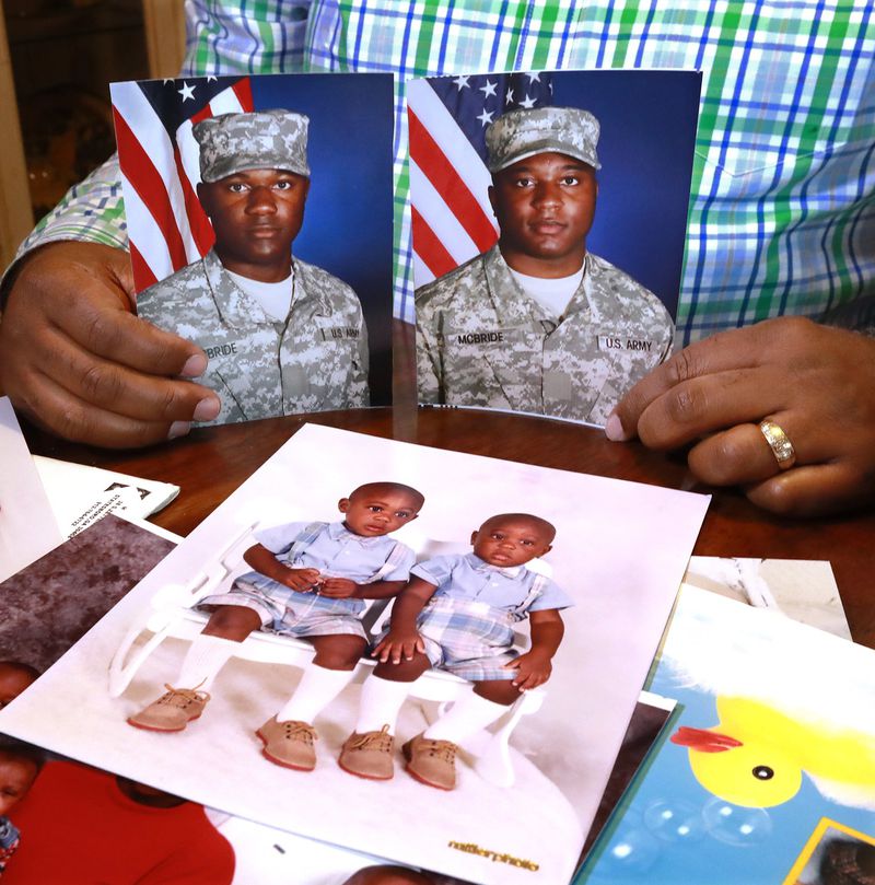 Chris McBride holds photos of his twin sons Matthew and Ryan at their home in Statesboro. “I just keep the thought in the forefront of my mind that: They are going over. They are going to perform their duty and they are going to come back home,” Chris said. “If something else happens between now and then, I will cross that bridge then. But for right now, I am not even thinking about that. I don’t want to think about it.” Curtis Compton/ccompton@ajc.com