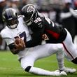 Baltimore Ravens quarterback Josh Johnson is sacked by Atlanta Falcons defensive tackle Ruke Orhorhoro during the first half of a preseason NFL football game on Saturday, Aug. 17, 2024, in Baltimore. (AP Photo/Nick Wass)