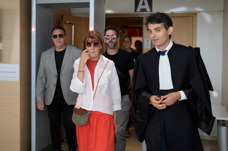 Gisele Pelicot, centre left, leaves the Avignon court house with her sons, David, left, Florian, center background and her lawyer Stephane Babonneau, right, in Avignon, southern France, Thursday, Sept. 5, 2024. A woman allegedly drugged by her ex-husband so that she could be raped by other men while she laid unconscious, is expected to testify before a panel of French judges. (AP Photo/Lewis Joly)