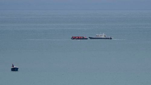 A boat thought to be with migrants is escorted by a vessel from the French Gendarmerie Nationale off the Wimereux beach, France, Wednesday, Sept. 4, 2024. A boat carrying migrants ripped apart in the English Channel as they attempted to reach Britain from northern France on Tuesday, plunging dozens into the treacherous waterway and leaving 12 dead, authorities said. (AP Photo/Nicolas Garriga)