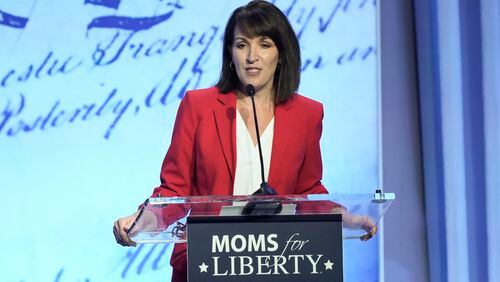 FILE - Moms for Liberty co-founder Tina Descovich speaks at the Moms for Liberty meeting in Philadelphia, June 30, 2023. The conservative parental rights group Moms for Liberty plans to spend more than $3 million on a multi-state advertising blitz to increase its membership and engage voters before November. (AP Photo/Matt Rourke)