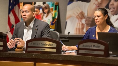 The Atlanta school board  chairman Jason Esteves(left) & superintendent Meria Carstarphen's  listen to public comment during a special meeting to discuss whether to extend Carstarphen's contract. (Photo by Phil Skinner).